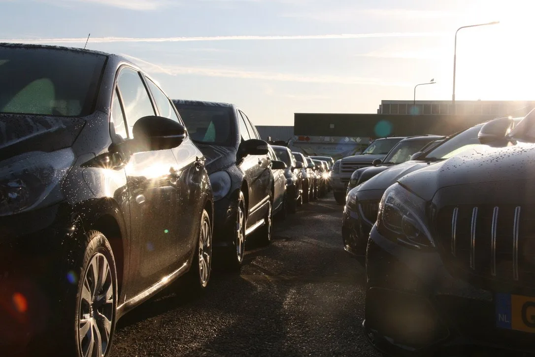 Originele occasions op het terrein van Junior Automotive in het avondlicht